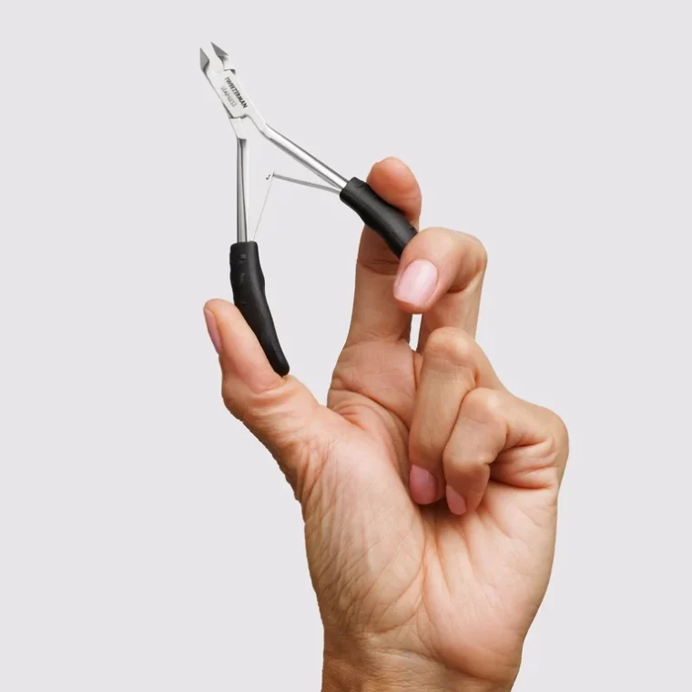 Tweezerman Cuticle Trimmer displayed on nail technician’s table in NYC